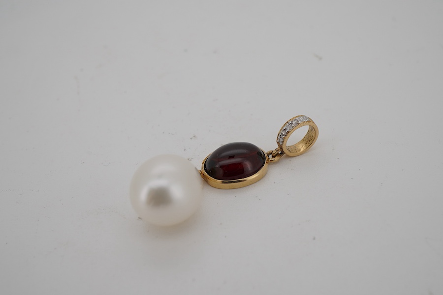 A modern 18k, cabochon garnet and cultured pearl set drop pendant, with two stone diamond set bale, approximately 30mm, gross weight 2.8 grams.
